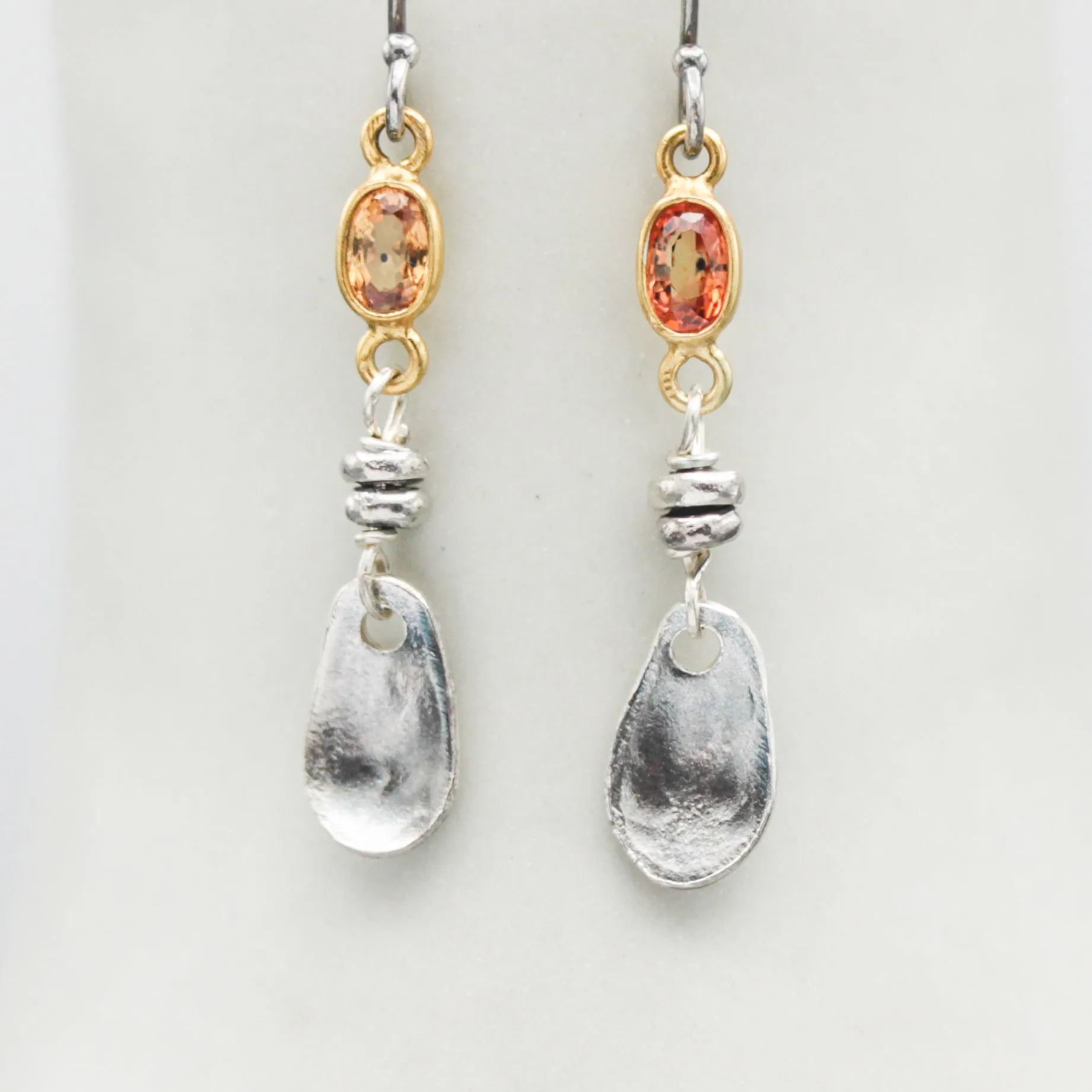 Orange sapphire earrings in bezel setting with silver leaf on sterling silver hooks style