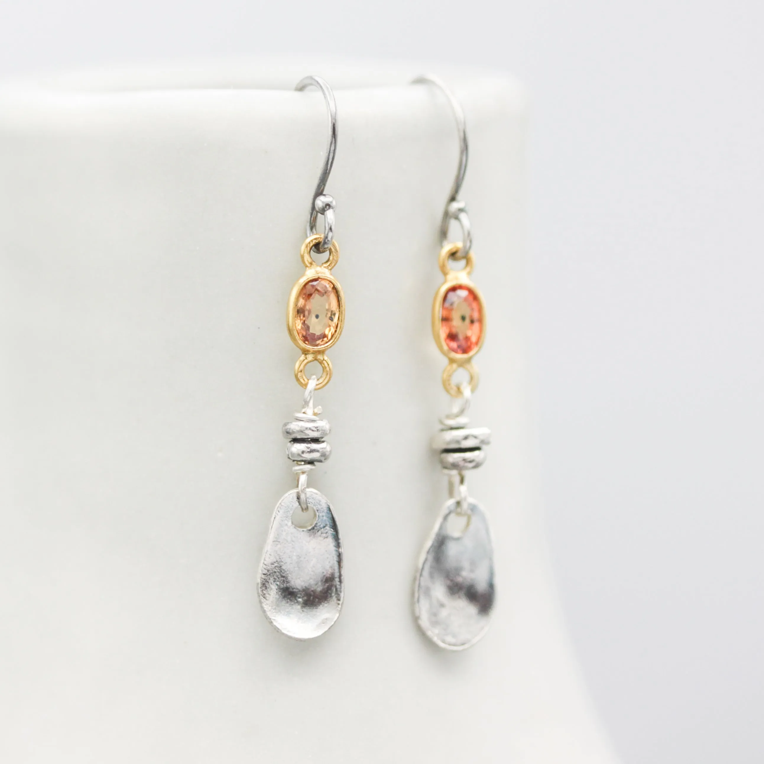 Orange sapphire earrings in bezel setting with silver leaf on sterling silver hooks style